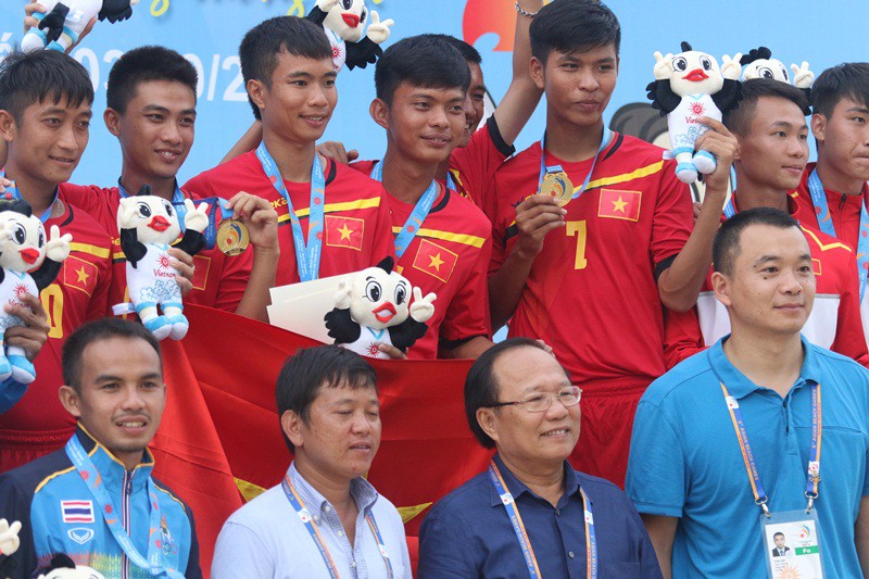 Chủ tịch Ủy ban Olympic Việt Nam Hoàng Tuấn Anh (đeo kính) chụp ảnh lưu niệm của đội tuyển đá cầu nam