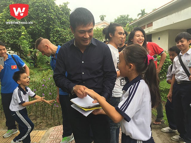 HLV Nguyễn Hữu Thắng thân thiện nở nụ cười sau khi ký tặng một bé gái.