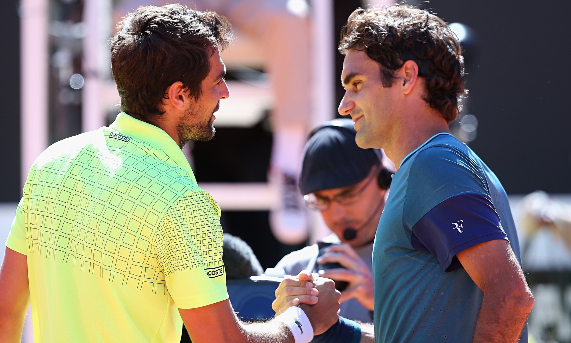 Roger Federer, right, congratulates Jeremy Chardy, who beat the Swiss 1-6, 6-3, 7-6 at the Rome Open