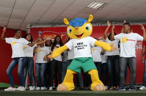Youths from the Morro dos Macacos slum dance with the official 2014 World Cup mascot during the mascot's presentation in Rio de Janeiro