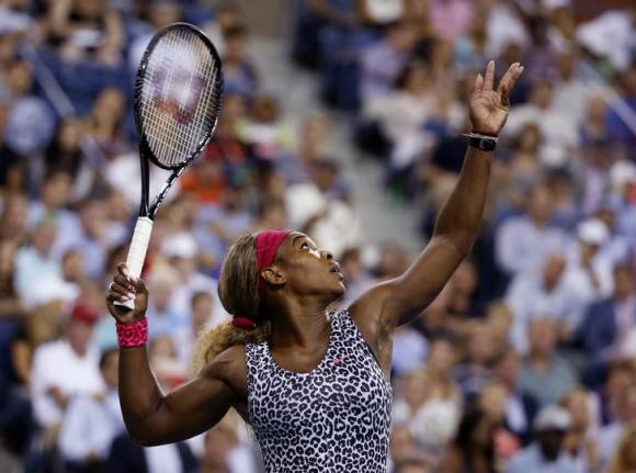 Serena Williams of the U.S. serves to Flavia Pennetta of Italy in their quarter-final women's singles match at the 2014 U.S. Open tennis tournament in New York