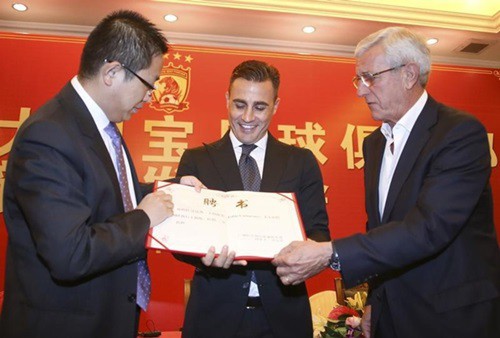 Former Italian soccer player Fabio Cannavaro holds the letter of appointment during a news conference announcing him as the new coach of Guangzhou Evergrande Taobao Football Club in Guangzhou