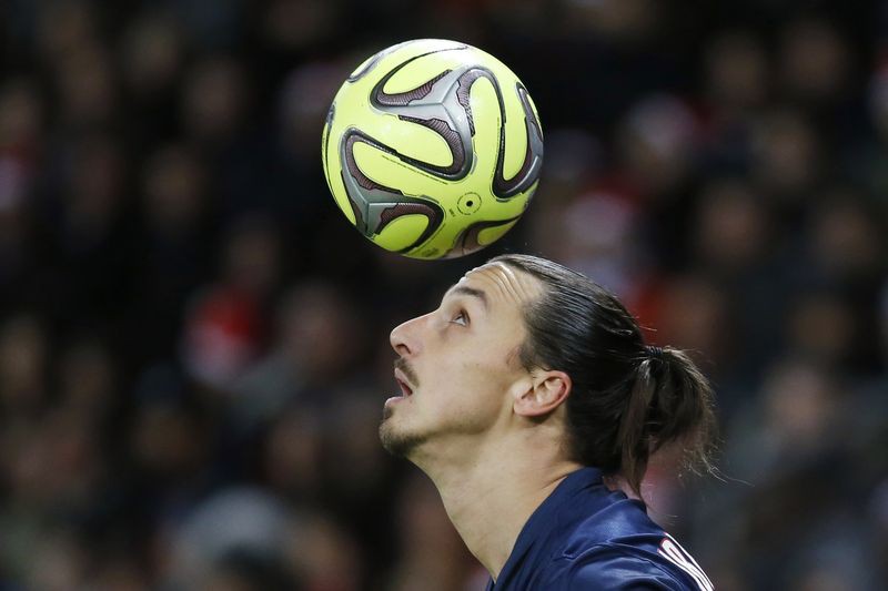 Paris Saint Germain's Zlatan Ibrahimovic heads the ball during their French Ligue 1 soccer match against Montpellier at Parc des Princes stadium in Paris, December 20, 2014. REUTERS/Charles Platiau (FRANCE - Tags: SPORT SOCCER)