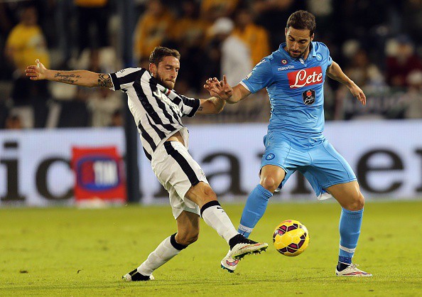 Juventus FC's Italian midfielder Claudio Marchisio (L) attempts a tackle on Napoli's Argentine striker Gonzalo Higuain during their Italian Super Cup football match - which is contested between the 2014 Serie A Champions (Juventus) and the 2014 Coppa Italia Holders (Napoli) - at the Sheikh Jassim Bin Hamad Stadium, in the Qatari capital, Doha on December 22, 2014.  AFP PHOTO / AL-WATAN DOHA / KARIM JAAFAR ==QATAR OUT==        (Photo credit should read KARIM JAAFAR/AFP/Getty Images)