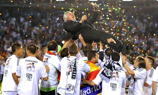VALENCIA, SPAIN - APRIL 16:  Head coach Carlo Ancelotti of Real Madrid is thrown into the air by his players after Real beat Barcelona 2-1 in the  Copa del Rey Final between Real Madrid and Barcelona at Estadio Mestalla on April 16, 2014 in Valencia, Spain.  (Photo by Denis Doyle/Getty Images)