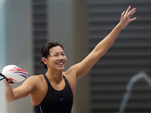 Nguyen Thi Anh Vien of Vietnam waves to supporters after she wins the  Women's 200m Freestyle Final at the SEA Games in Singapore, Tuesday, June 9, 2015. (AP Photo/Joseph Nair)