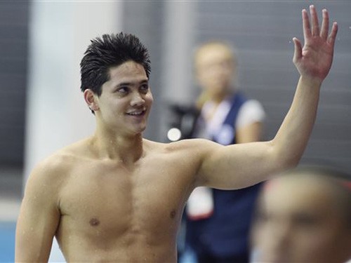Joseph Schooling of Singapore waves to the crowd after winning the Men's 200m Butterfly final at the SEA Games in Singapore, Monday, June 8, 2015. (AP Photo/Joseph Nair)