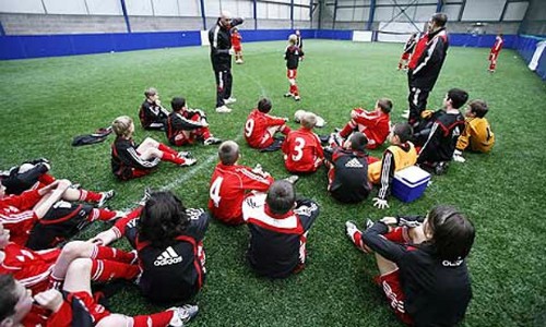 Players at the Liverpool academy listen to their coaches