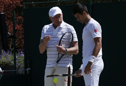Coach Boris Becker talks to Novak Djokovic of Serbia during a practice session at the Wimbledon Tennis Championships in London, July 9, 2015.                               REUTERS/Suzanne Plunkett